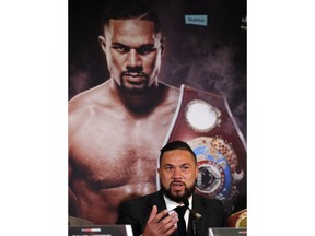 New Zealand's Joseph Parker speaks in front of his picture during a media conference with World Heavyweight boxer Anthony Joshua of Britain in London, Tuesday, Jan. 16, 2018. Their unification title bout with Joshua's IBF, WBA (Super) and IBO heavyweight titles and Parker's WBO heavyweight title on the line will take place at the Principality Stadium in Cardiff on March 31, 2018.