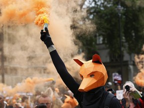 FILE - In this file photo dated Tuesday, July 14, 2015, a protestors dressed as a fox demonstrates to keep a ban on fox hunting, near to the Houses of Parliament in London.  During a TV interview broadcast Sunday Jan. 7, 2018, Prime Minister Theresa May said the British government is scrapping a promise to reconsider the current ban on fox hunting until after the next election, due in 2022, a centuries-old rural tradition contentiously outlawed more than a decade ago.