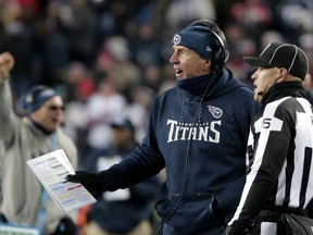 Tennessee Titans head coach Mike Mularkey speaks to down judge Jerod Phillips on the sideline during the first half of an NFL divisional playoff football game against the New England Patriots, Saturday, Jan. 13, 2018, in Foxborough, Mass.