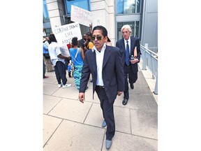 FILE - In this July 8, 2016, file photo, Elias "Ronnie" Simmons, former Chief of Staff for U.S. Rep. Corrine Brown, of Florida, leaves the Federal Courthouse, in Jacksonville, Fla. Simmons arrived Monday, Jan. 8, 2018, as scheduled at a medium-security federal prison in Cumberland, Md. Once a powerful Democrat, Brown was found guilty last year of taking money from a charity that purported to award scholarships to poor students.