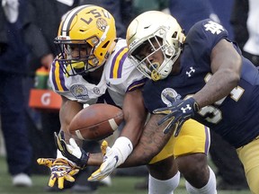 LSU linebacker K'Lavon Chaisson, left, breaks up a pass intended for Notre Dame running back Tony Jones Jr. during the first half of the Citrus Bowl NCAA college football game, Monday, Jan. 1, 2018, in Orlando, Fla.