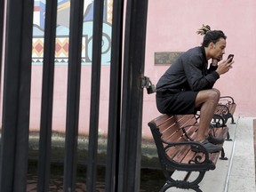 New York Jets wide receiver Robby Anderson sits on a bench in Fort Lauderdale, Fla., as he waits for a ride after being released from the Broward County Jail on Friday, Jan. 19, 2018. Anderson faces a slew of charges, including threatening a police officer's family and saying he would rape the officer's wife. A Sunrise, Fla., police report shows the 24-year-old Anderson was stopped early Friday in a sport utility vehicle after it ran two red lights and was swerving while traveling about 105 mph (168 kph).