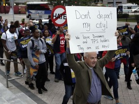 Frank Corbishley, of Coral Gables, Fla., marches in support of Deferred Action for Childhood Arrivals (DACA) and Temporary Protected Status (TPS) programs Wednesday, Jan. 17, 2018, in Miami.