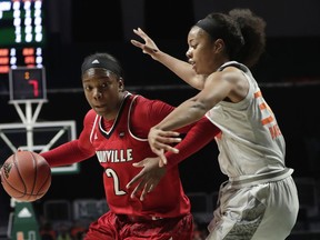 Louisville's Myisha Hines-Allen (2) drives to the basket as Miami's Erykah Davenport (30) defends during the first half of an NCAA college basketball game, Thursday, Jan. 25, 2018, in Coral Gables, Fla.