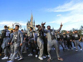 Central Florida football players celebrate during the a parade at Walt Disney World in the Magic Kingdom on Sunday, Jan. 7, 2018, in Orlando, Fla.