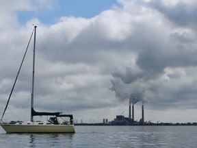 A sailboat glides between Pine Key and the TECO power plant at Big Bend off Apollo Beach, Fla., Wednesday, Jan. 10, 2018.