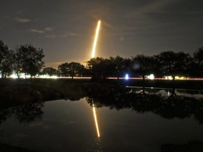 In this image made with a long exposure the SpaceX Falcon 9 rocket launches from Cape Canaveral Air Force Station as seen from in Viera, Fla., Sunday, Jan. 7, 2018. SpaceX has launched a secret satellite codenamed Zuma on its first flight of the new year.