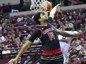 Florida State's Phil Cofer shoots around the defense of Louisville's Anas Mahmoud in the first half of an NCAA college basketball game, Wednesday, Jan. 10, 2018, in Tallahassee, Fla.