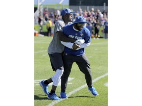 NFC running back Mark Ingram, right, of the New Orleans Saints, and linebacker Thomas Davis Sr., of the Carolina Panthers, wrestle during Pro Bowl NFL football practice, Wednesday, Jan. 24, 2018, in Kissimmee, Fla.
