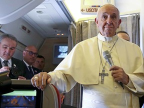 Pope Francis talks to journalists onboard the plane for his trip to Chile and Peru, Monday, Jan. 15, 2018.