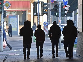 FILE - In this Jan. 19, 2016 file photo migrants walk in the so-called "Mahgreb Quarter" in Duesseldorf, Germany. German Interior Minister Thomas de Maiziere will present the latest migrant statistic on Tuesday, Jan. 16, 2018.