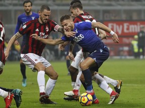 AC Milan's Leonardo Bonucci, left, and Lazio's Ciro Immobile vie for the ball during the Italian Cup, first-leg semifinal soccer match between AC Milan and Lazio, at the Milan San Siro stadium, Italy, Wednesday, Jan. 31, 2018.