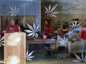 FILE  - In this Dec. 21, 2017 file photo, bud tenders wait for customers at MedMen, a medical marijuana dispensary in Los Angeles. Attorney General Jeff Sessions has rescinded an Obama-era policy that paved the way for legalized marijuana to flourish in states across the country, creating new confusion about enforcement and use just three days after a new legalization law went into effect in California.