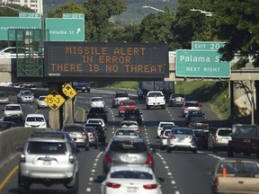 FILE - In this Saturday, Jan. 13, 2018 file photo provided by Civil Beat, cars drive past a highway sign that says "MISSILE ALERT ERROR THERE IS NO THREAT" on the H-1 Freeway in Honolulu. Gov. David Ige has appointed state Army National Guard Brig. Gen. Kenneth Hara as new head of Hawaii's emergency management agency after a faulty alert was sent to cellphones around the state warning of an incoming missile attack.