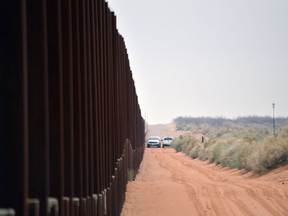 File - In this Jan. 5, 2016 file photo, U.S. Border Patrol vehicles drive next to a U.S-Mexico border fence in the booming New Mexico town of Santa Teresa. The Trump administration is waiving numerous laws to clear the way for replacing existing vehicle barriers along a stretch of the US-Mexico border in New Mexico. The notice published Monday, Jan. 22, 2018, in the Federal Register says the waiver extends around 20 miles west of the Santa Teresa Port of Entry.