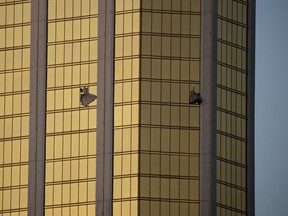 FILE - In this Monday, Oct. 2, 2017 file photo, drapes billow out of broken windows at the Mandalay Bay resort and casino on the Las Vegas Strip, following a mass shooting at a music festival in Las Vegas. A lawyer for Las Vegas police told a judge on Jan. 16, 2018, that charges could be filed in connection with the deadliest mass shooting in modern U.S. history, even though the gunman is dead.