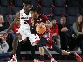 South Carolina guard Wesley Myers (15) drives past Georgia forward Rayshaun Hammonds (20) in the first half of an NCAA college basketball game in Athens, Ga., Saturday, Jan. 13, 2018.