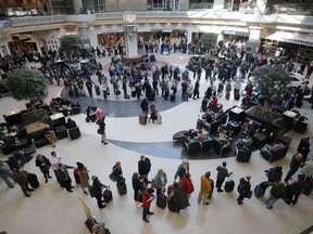 Security lines wrap through the atrium and around the baggage areas at Hartsfield-Jackson International Airport on Wednesday, Jan. 17, 2018 in the wake of a snowstorm. Hartsfield-Jackson Atlanta International Airport said in a statement that crews were de-icing airplanes as wintry weather moved into metro Atlanta.