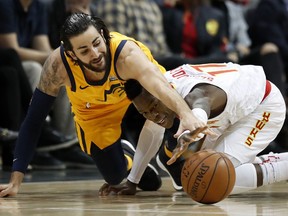 Utah Jazz's Ricky Rubio, of Spain, left, reaches for a loose ball against Atlanta Hawks' Dennis Schroder, of Germany, in the first quarter of an NBA basketball game in Atlanta, Monday, Jan. 22, 2018.