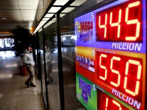 A sign advertises Powerball and Mega Millions lottery jackpots at a store in Atlanta, Thursday, Jan. 4, 2018. An estimated $550 million jackpot is up for grabs on Saturday night's Powerball lottery drawing, making it potentially the 8th largest prize in the nation.