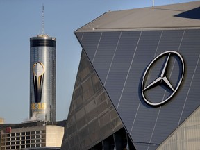 A logo for the NCAA college football championship game decorates a building next to Mercedes-Benz Stadium Thursday, Jan. 4, 2018, in Atlanta, where the game will be played on Monday. Atlanta's mayor is promising a "safe, smooth and secure" college football championship game Monday, despite the traffic problems expected to be caused by President Donald Trump's motorcade, but none of the many agencies involved are taking any chances.