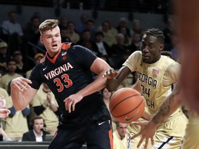 Virginia center Jack Salt (33) and Georgia Tech forward Abdoulaye Gueye (34) battle for the ball during the first half of an NCAA college basketball game Thursday, Jan. 18, 2018, in Atlanta.