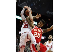 Chicago Bulls guard Ryan Arcidiacono (15) is fouled by Atlanta Hawks forward John Collins (20) as they battle for a rebound during the first half of an NBA basketball game Saturday, Jan. 20, 2018, in Atlanta.