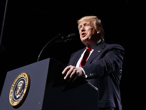 FILE - In this April 28, 2017, file photo, President Donald Trump speaks in Atlanta. Trump disparaged the city as "crime infested" and falling apart" after the city's Democratic congressman, Rep. John Lewis, announced he would not attend Trump's inauguration. Atlanta residents didn't forget those comments, and some think he is being hypocritical by attending the college football championship at the city's new stadium on Monday, Jan. 8.