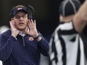 Auburn head coach Gus Malzahn speaks to an official during the first half of the Peach Bowl NCAA college football game between Central Florida and Auburn, Monday, Jan. 1, 2018, in Atlanta.