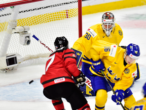 Canadian Tyler Steenbergen scores the winning goal against Sweden goaltender Filip Gustavsson in the third period of the gold medal World Junior Championship game in Buffalo.