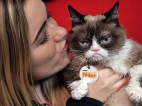 Grumpy Cat poses for photos with her owner, Tabatha Bundesen, in New York.