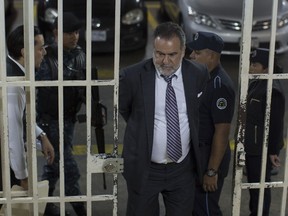 Ingmar Walterio Iten Rodriguez, a Guatemalan businessman, is transferred in handcuffs through the basement of a courthouse after his arrest in Guatemala City, Thursday, Jan. 25, 2018. Iten Walterio is one of several Guatemalan businessmen and former government officials arrested on charges of corruption and tax evasion.