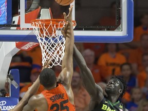 Florida forward Keith Stone (25) shoots over Baylor forward Jo Lual-Acuil Jr. (0) during the first half of an NCAA college basketball game in Gainesville, Fla., Saturday, Jan. 27, 2018.