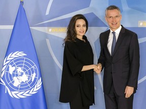 NATO Secretary General Jens Stoltenberg, right, welcomes the Special Envoy for the United Nations High Commissioner for Refugees Angelina Jolie at NATO headquarters in Brussels, Wednesday, Jan. 31, 2018.