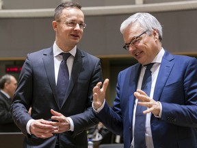 Belgium Foreign Minister Didier Reynders, right, talks with Hungary Foreign Minister Peter Szijjarto during an EU foreign ministers meeting at the EU Council in Brussels on Monday, Jan. 22, 2018.