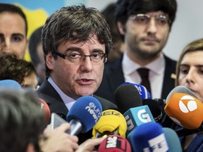 Ousted Catalan leader Carles Puigdemont addresses the media after a meeting with the President of the Parliament of Catalonia Roger Torrent in Brussels on Wednesday, Jan. 24, 2018.