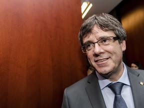 Ousted Catalan leader Carles Puigdemont arrives to address the media after a meeting with the President of the Parliament of Catalonia Roger Torrent in Brussels on Wednesday, Jan. 24, 2018.