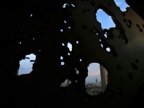 A mosque in the Bab Dreib neighborhood shows through a hole in a damaged building in the old city of Homs, Syria, Tuesday, Jan. 16, 2018. Elsewhere in Syria, several civilians were killed and others were wounded by insurgent shelling Tuesday of Aleppo city, the state-run news agency SANA reported.