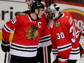 Chicago Blackhawks captain Jonathan Toews, left, congratulates winning goaltender Jeff Glass following a 2-1 win over the Winnipeg Jets in NHL action Friday at the United Center. Glass made 31 saves to improve his record to 3-1-1 on the season.