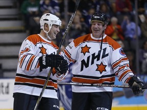 Eric Lindros and former Legion of Doom linemate John LeClair skate at the Hockey Hall of Fame Legends Classic Game in Toronto on Nov. 13, 2016.
