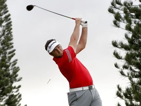 Jon Rahm plays his shot from the 18th tee during the final round of the Tournament of Champions golf event, Sunday, Jan. 7, 2018, at Kapalua Plantation Course in Kapalua, Hawaii.