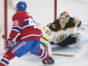Boston Bruins goaltender Tuukka Rask looks on as the Canadiens' Logan Shaw hits the post with a shot during third period action in Montreal on Saturday night.