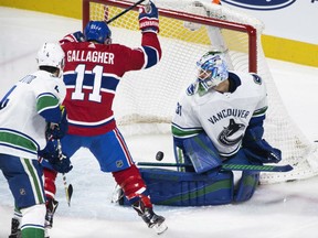 Vancouver Canucks goaltender Anders Nilsson is scored on by Montreal Canadiens' Alex Galchenyuk (not shown) as Canucks' Michael Del Zotto and Canadiens' Brendan Gallagher look on during the second period in Montreal, Sunday.