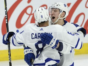 Toronto Maple Leafs defenceman Connor Carrick is congratulated by teammate Travis Dermott after scoring the go-ahead goal against the Senators during third period NHL action in Ottawa on Saturday night.