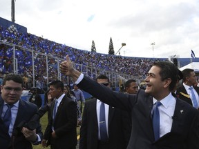 Honduran President Juan Orlando Hernandez gives a thumbs up to supporters as he arrives to be sworn in for a second term, at the National Stadium in Tegucigalpa, Honduras, Saturday, Jan. 27, 2018. The opposition does not recognize Hernandez's victory following disputed poll results, and has been protesting ahead of his Jan. 27 swearing-in ceremony.