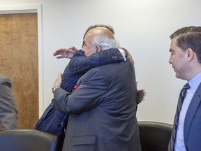 This March 29, 2017, photo obtained by the Associated Press, shows Robert Murray of Murray Energy, right, hugging Energy Secretary Rick Perry at the Department of Energy headquarters in Washington.