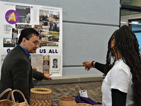 In a photo provided by the Cherokee Nation,  Cherokee Nation Secretary of State Chuck Hoskin Jr., left, looks over an exhibit about the Cherokee Freeman during a visit to the Martin Luther King Center in Muskogee, Okla., on Monday, Jan. 15, 2018. Leaders of the Cherokee Nation marked Martin Luther King Jr. Day by welcoming the descendants of slaves into their tribe after years of exclusion.