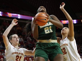 Baylor center Kalani Brown, center, drives to the basket between Iowa State's Bridget Carleton, left, and Meredith Burkhall, right, during the first half of an NCAA college basketball game, Wednesday, Jan. 17, 2018, in Ames, Iowa.