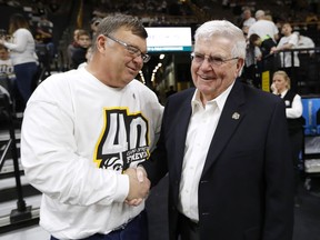 Mike Street, left, talks with former Iowa head basketball coach Tom Davis before an NCAA college basketball game between Iowa and Purdue, Saturday, Jan. 20, 2018, in Iowa City, Iowa. Street's son Chris, who played for Davis at Iowa, was killed in a collision with a snow plow on Jan. 19, 1993, in Iowa City.