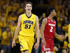 Iowa forward Nicholas Baer (51) celebrates in front of Wisconsin forward Aleem Ford (2) after making a 3-point basket during the first half of an NCAA college basketball game Tuesday, Jan. 23, 2018, in Iowa City, Iowa.